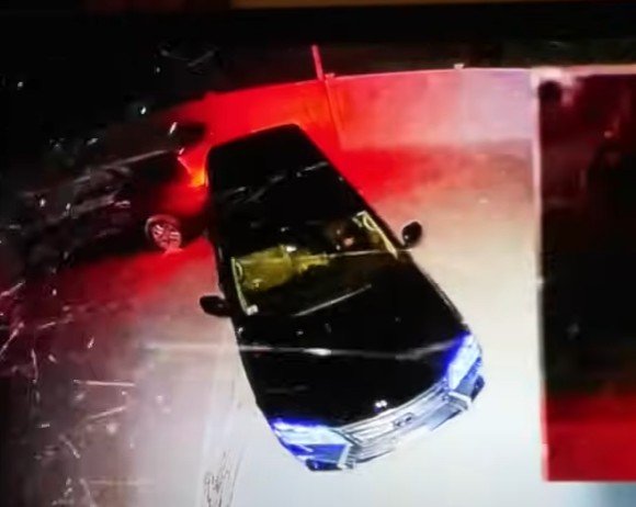 Karen backing into John OKeefe's car in his driveway with her Lexus.